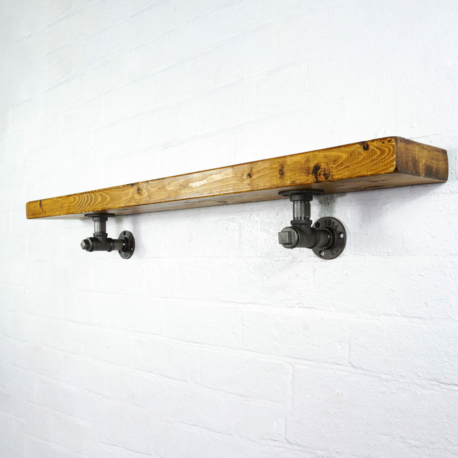 Raw steel industrial pipe tee nut shelving brackets with reclaimed wood scaffolding board shelf