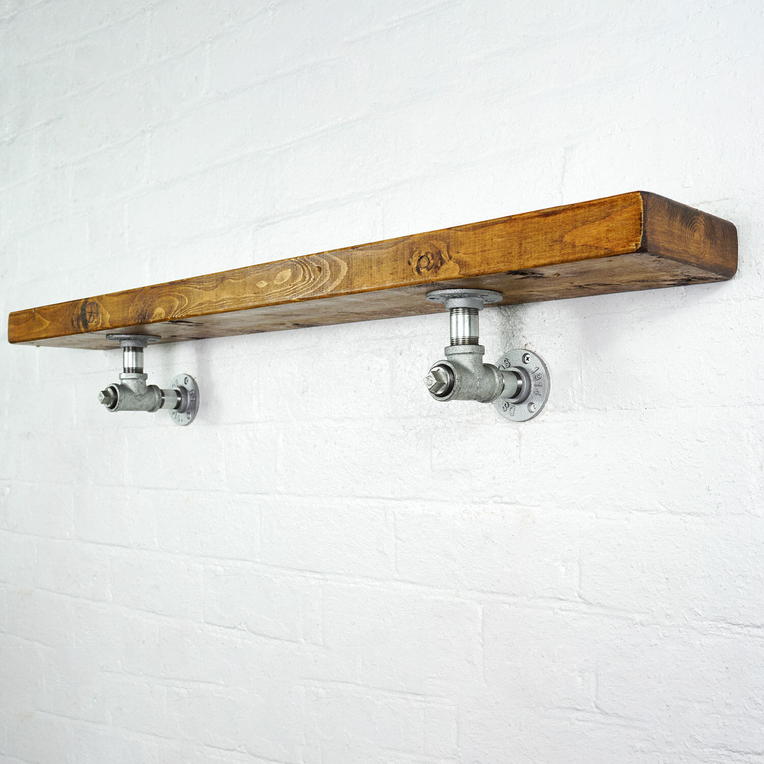 Galvanised industrial pipe with tee bracket shelving brackets with reclaimed wood scaffolding board shelf