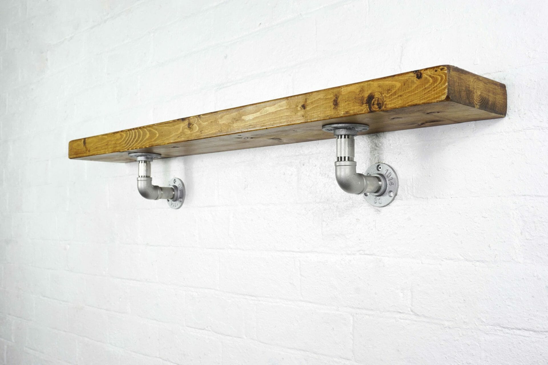Stainless steel industrial pipe shelving brackets with reclaimed wood scaffolding board shelf