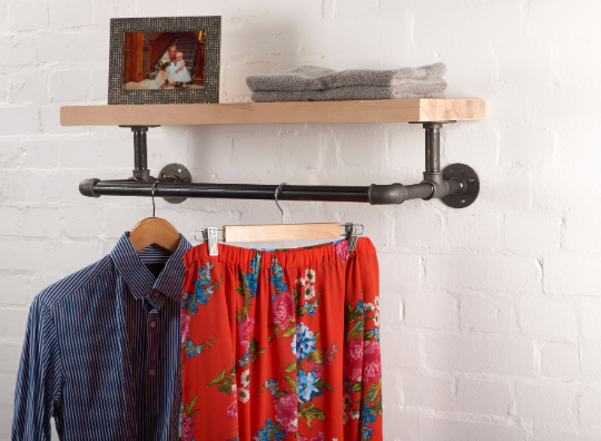 reclaimed wooden shelf with industrial steel pipe brackets and clothes rail