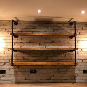 reclaimed wooden shelves wall mounted with industrial pipe brackets