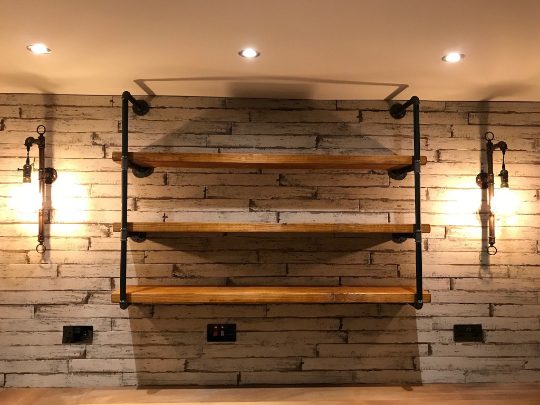 industrial steel pipe shelving unit with reclaimed wooden shelves