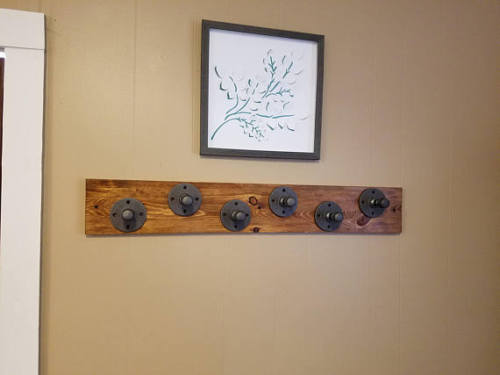 raw steel industrial pipe coat hooks with reclaimed wooden base