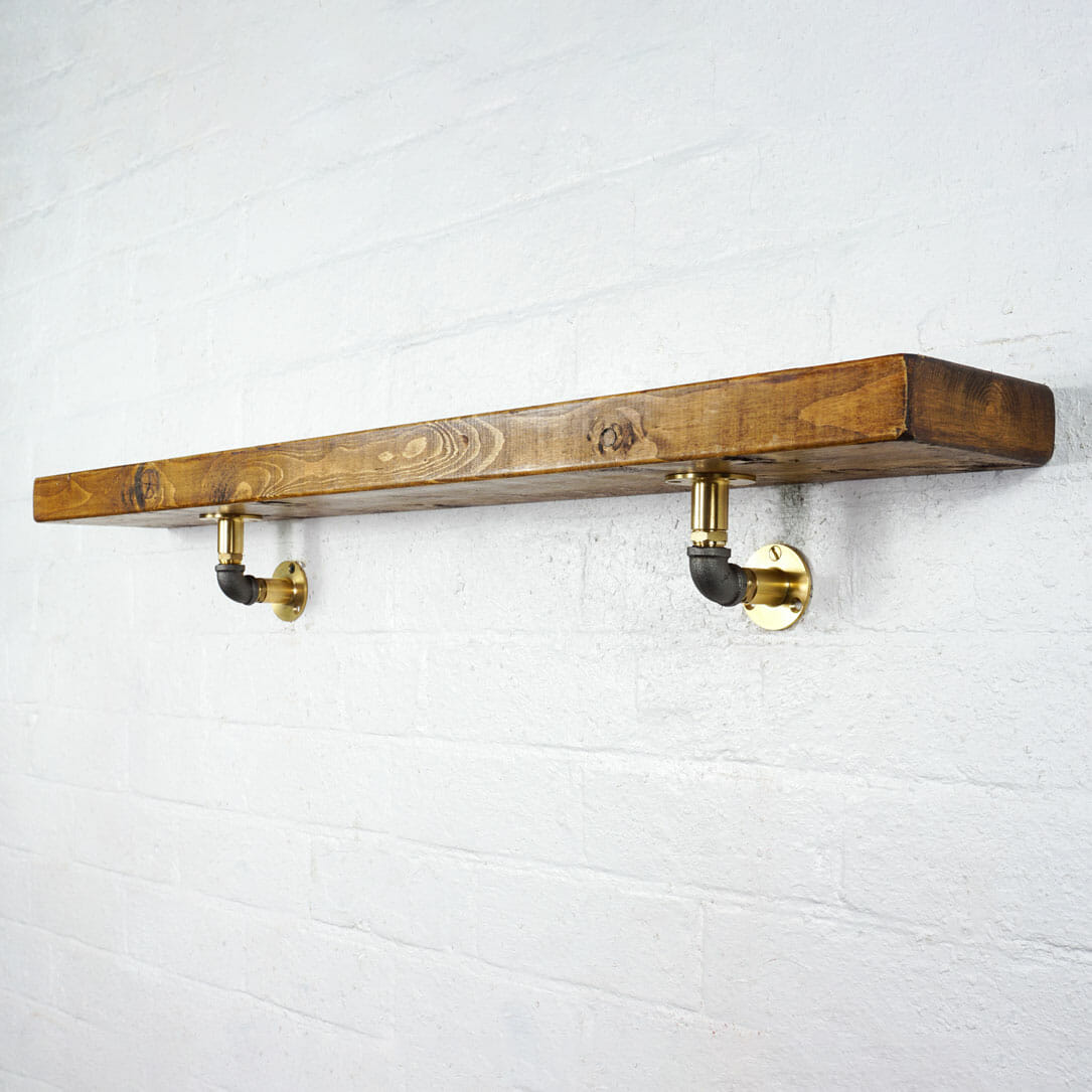 Brass industrial pipe with raw steel elbow shelf brackets with reclaimed wooden shelf