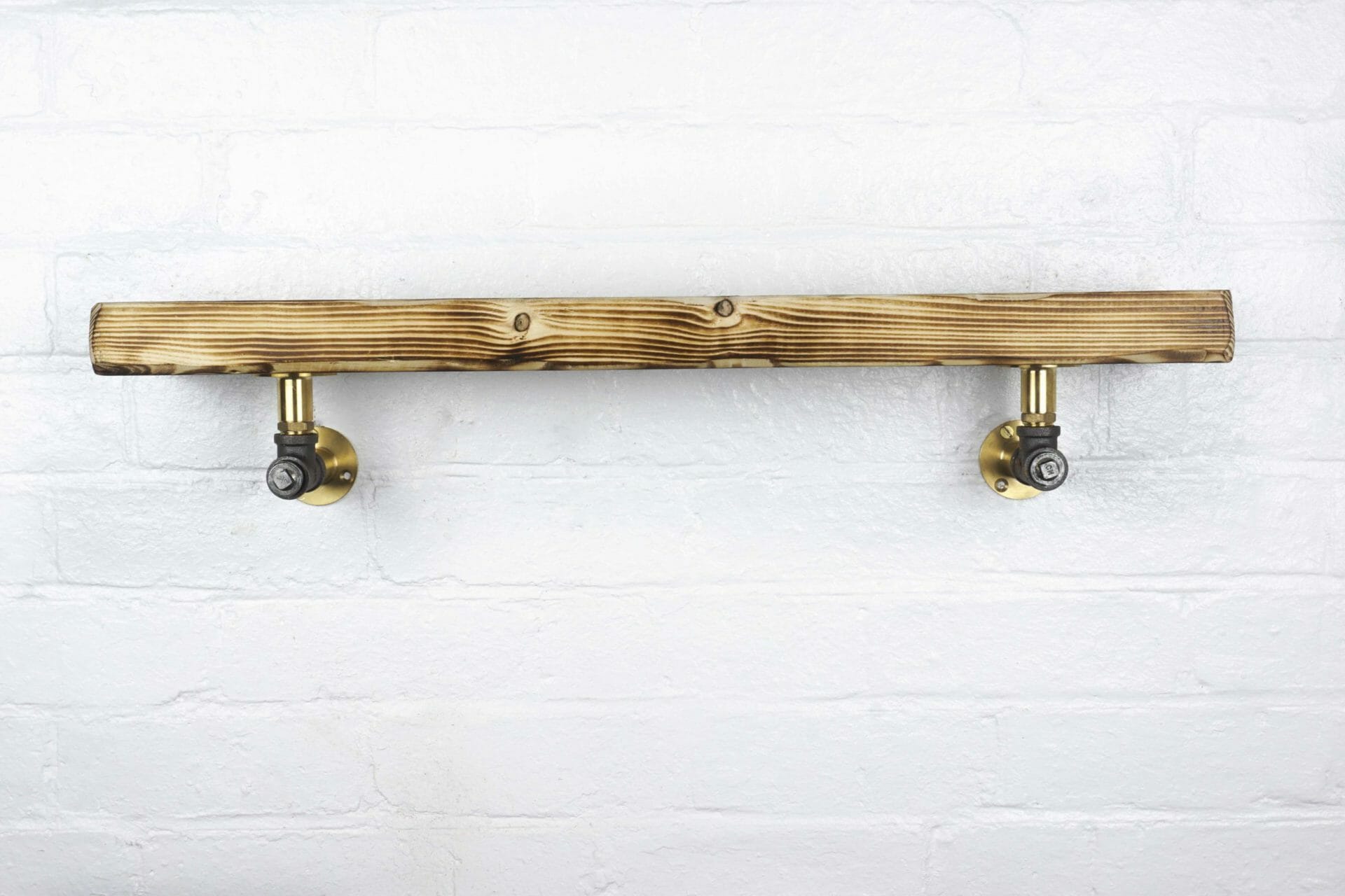 Grey steel and brass industrial pipe shelf brackets with burnt effect reclaimed wooden shelf
