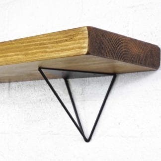 Black steel hairpin shelf brackets with reclaimed wooden shelf