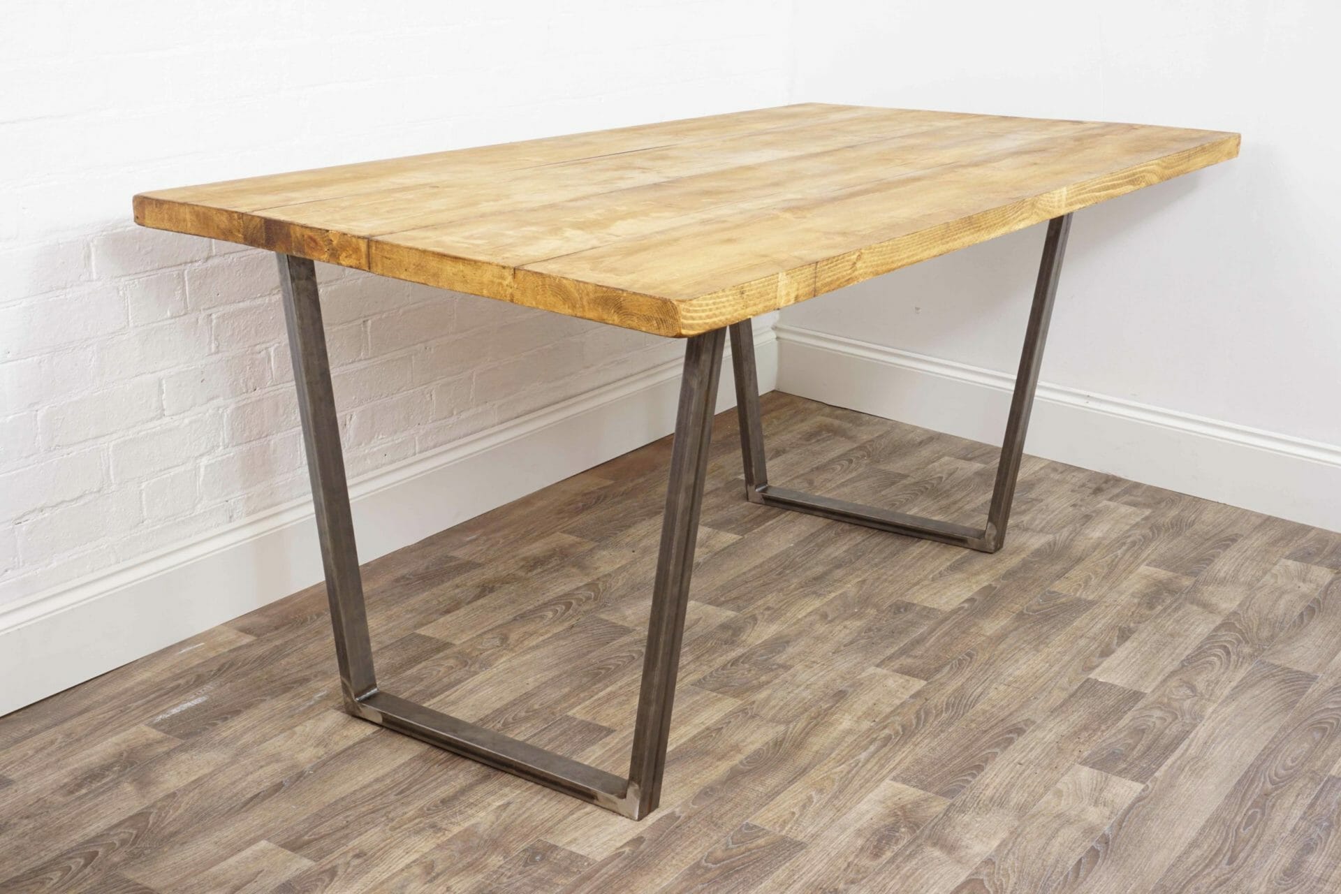reclaimed wooden table with reverse trapezium raw steel legs