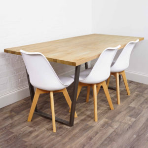 Solid wooden table with raw steel reverse trapezium legs